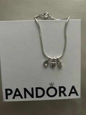 Pandora Sterling Silver Bracelet with three sterling silver charms